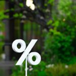 a white sign sitting on top of a puddle of water